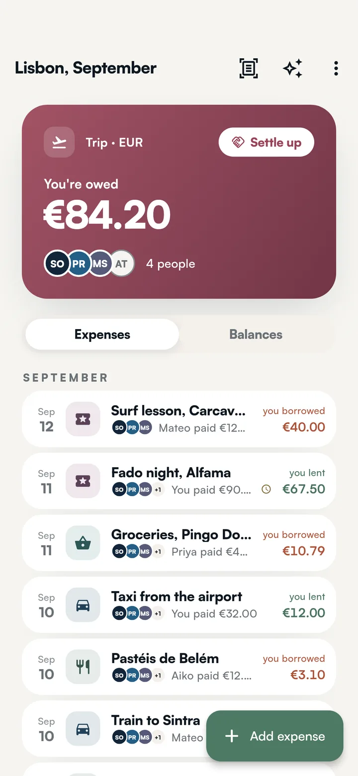The Lisbon group: what you are owed in a header in the group's own colour with a Settle up button and everyone's faces, then every expense with the faces of who shared it and what you lent or borrowed on each.